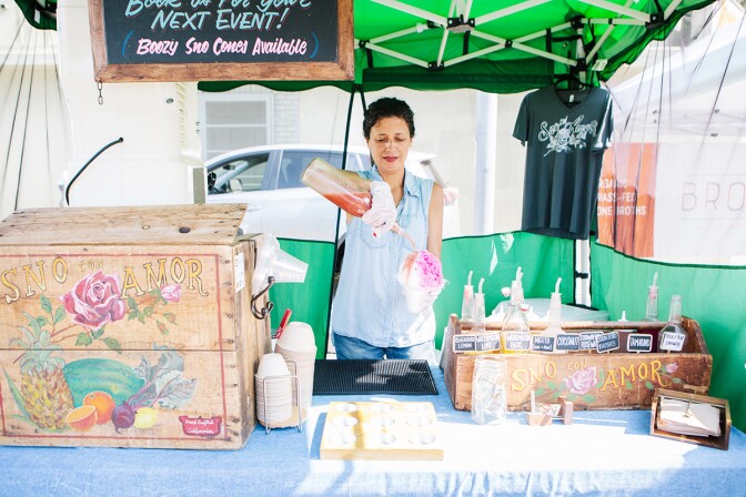 Sno con Amor's owner Lauda Flores making a snow cone in her stall at Hollywood Farmers' Market. | Jenny Kim