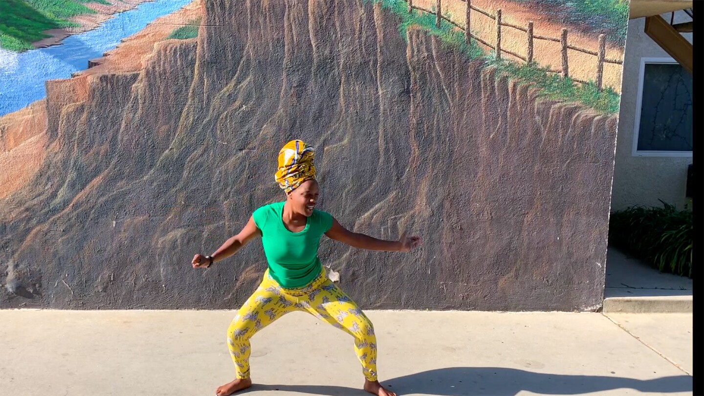 A young African American woman with a turban dances for one of Invertigo's Dance Care Package performances | Courtesy of Invertigo