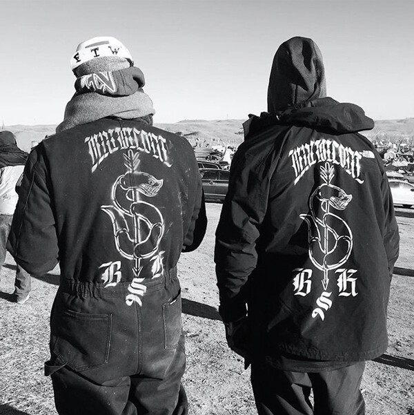 Artists Cannupa Hanska Luger and Jesse Hazelip at Oceti Sakowin Camp, Standing Rock. Luger's coveralls (left) will be on display at the Autry Museum.| Photo: courtesy Cannupa Hanska Luger.