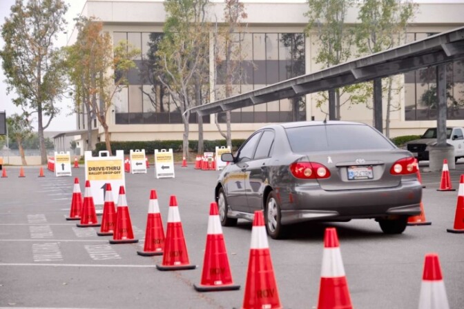 Cars wait in line for drop-off mail-in voting. | Chava Sanchez/LAist