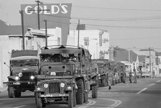 Los Angeles, CA: A convoy of trucks rolls into the Watts district loaded with National Guardsmen ordered in to the area to quell Watts Uprising. | Getty Images