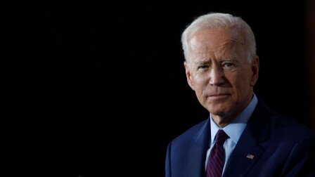 President Joe Biden against a dark background.