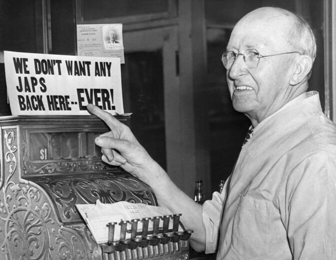 Barber Points to Anti-Japanese Sign