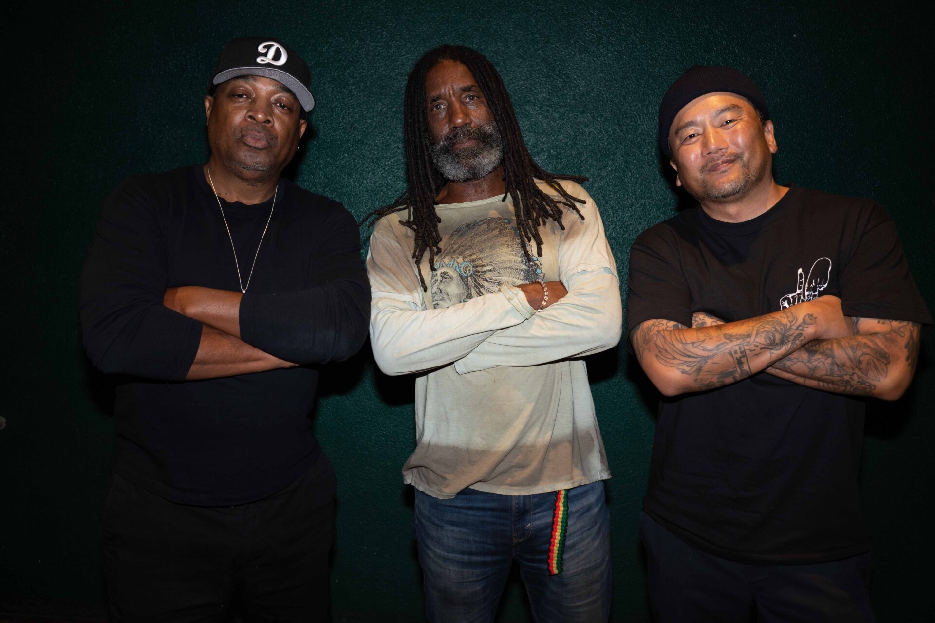 Three men with their arms crossed.