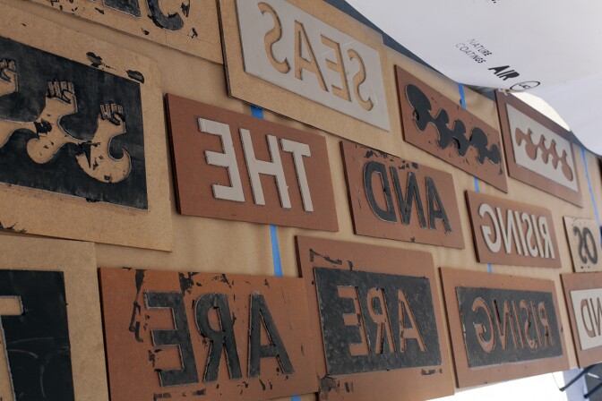 Stencils and stamps hang at a tent during the CicLAvia event at MacArthur Park in 2019. Created by Air artist Elana Mann, the interactive, eco-art project, titled "Dark Victory," invited participants to make custom prints with their bikes using eco-friendly ink.