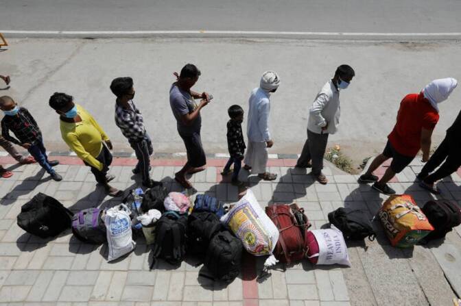 Photo from above of people waiting in line on a sidewalk.