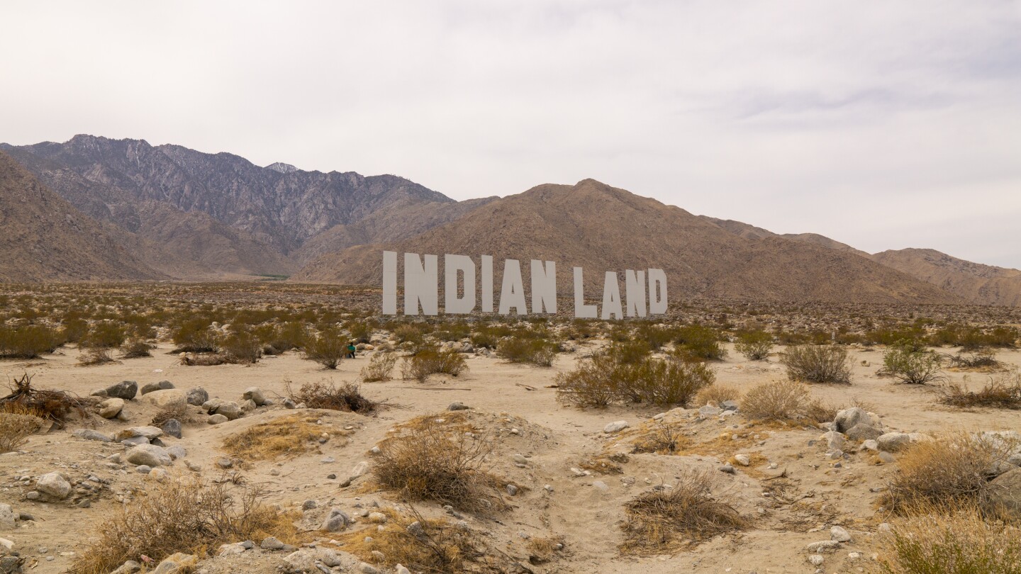 Nicholas Galanin's "Never Forget" installation consists of the words "Indian" and "Land" writ large like the Hollywood sign.