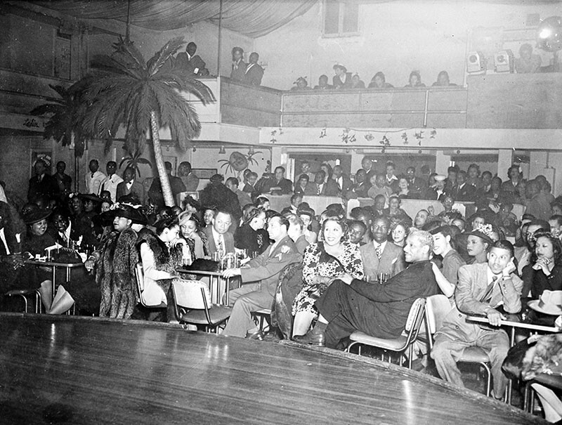 Audience watching a performance at Club Alabam, S. Central Avenue and 42nd Street, 1945. Identified are: actress Lillian Randolph (right of center), dancer Prince Spencer, Clarence Moore, Tillie Culison, Clehue McGee.
