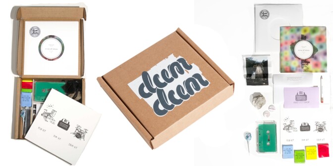 Contents of a 45-inch record mailer box are laid out on a white background. Some of the items are a dum dum lollipop, various prints, a folded up photo, a cassette tape, a small pencil and a rock.