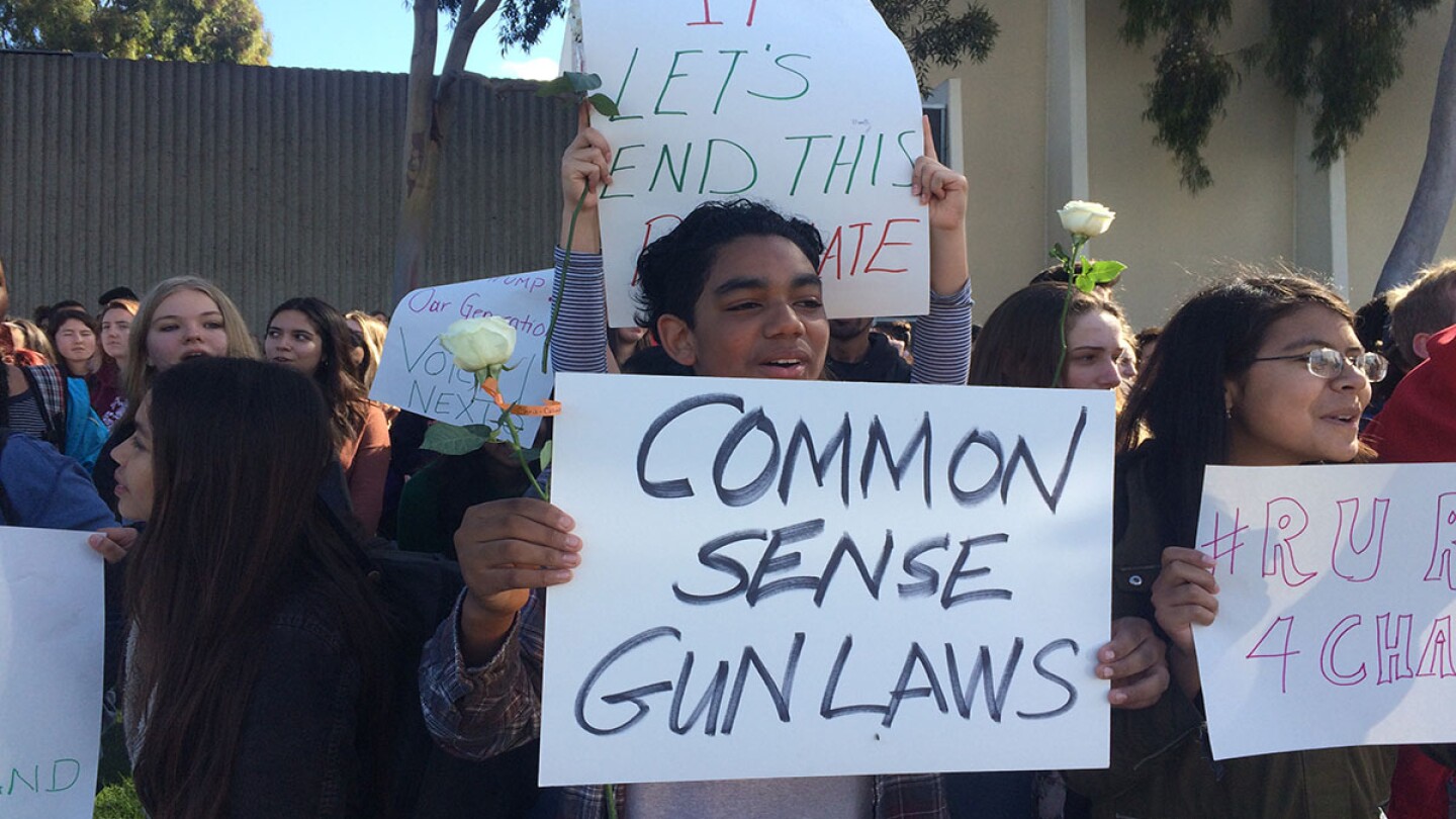 Student Holding Sign and Rose