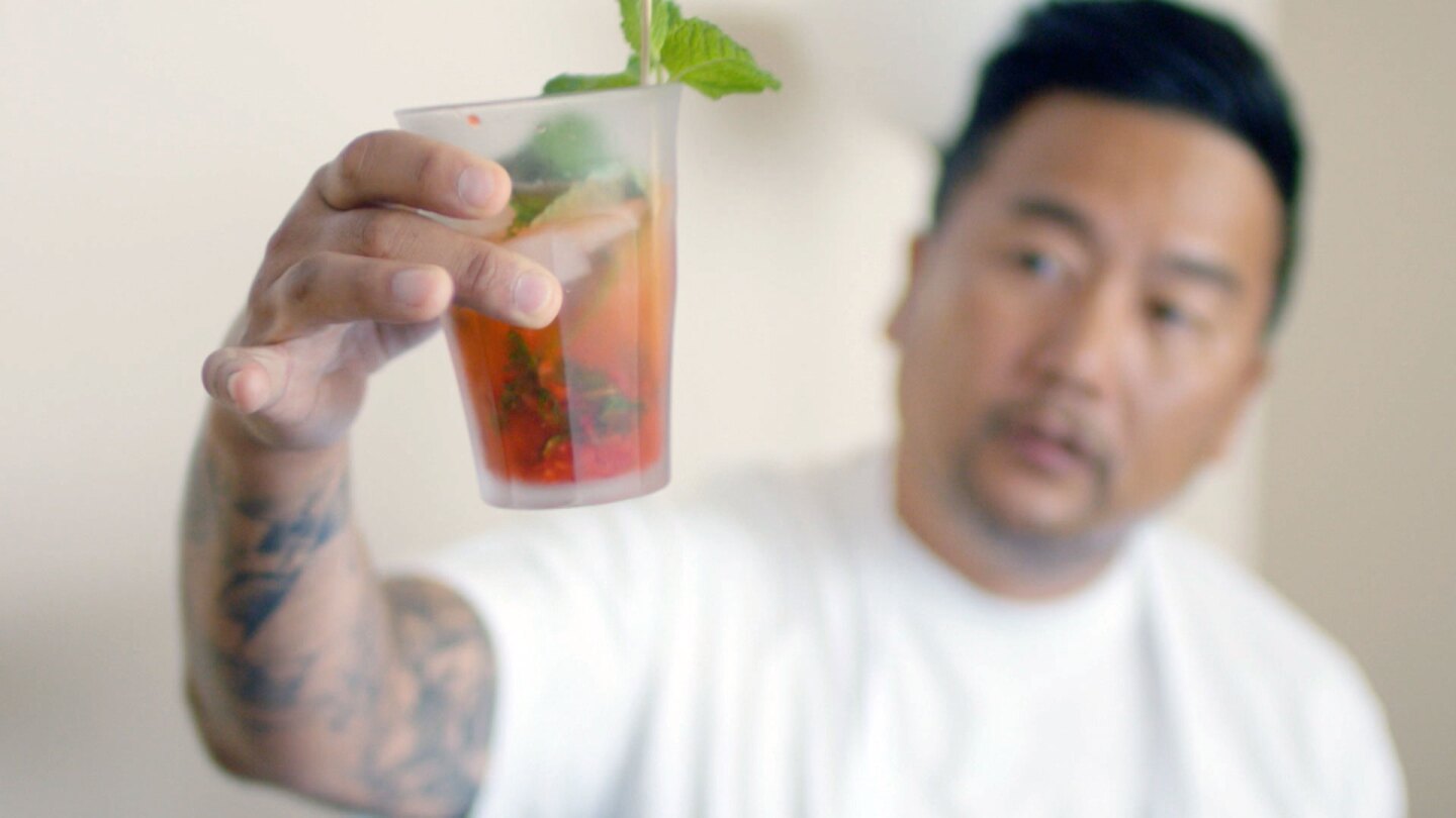 Roy Choi holds a drink infused with cannabis