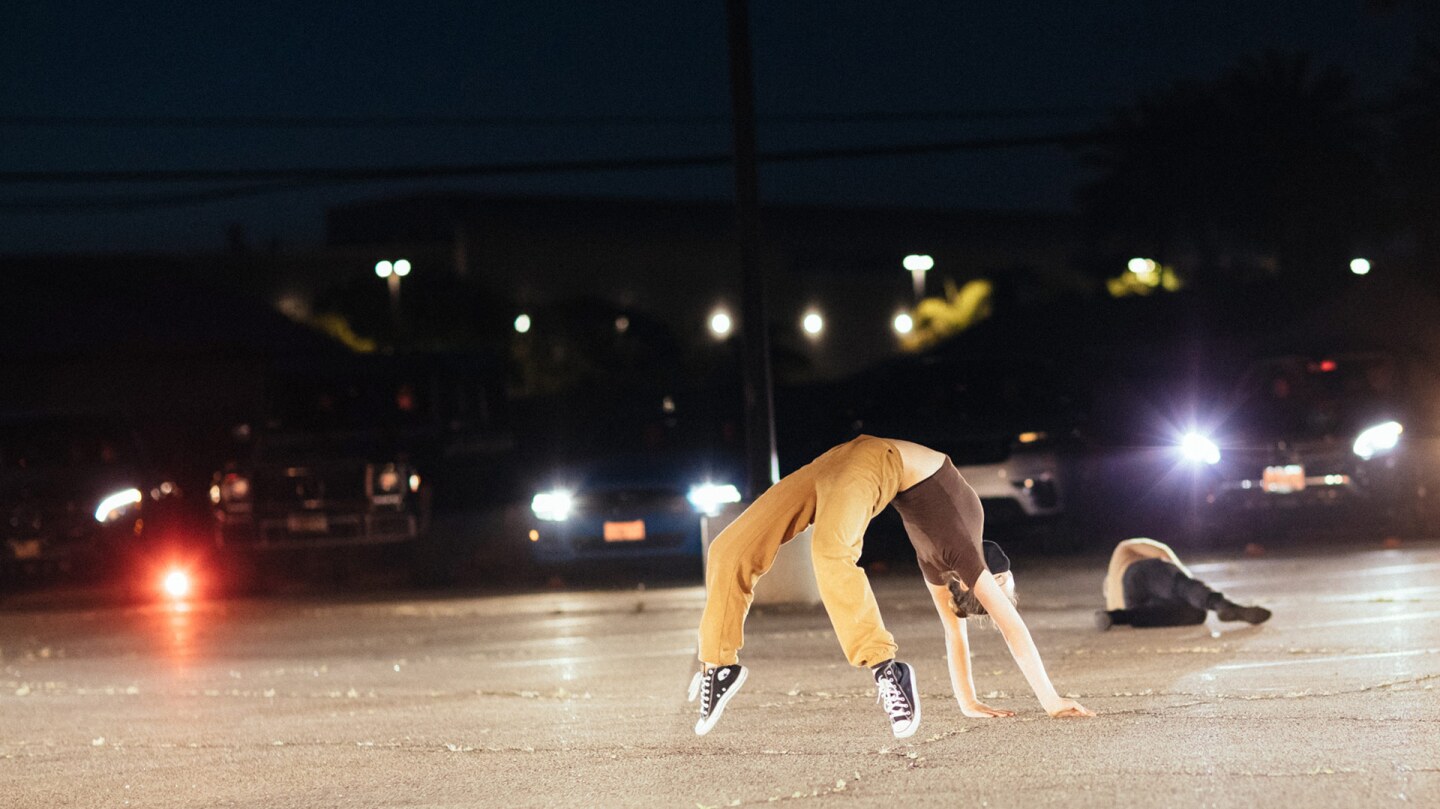 A dancer forms a bridge shape in "Parked." | Matthew Brush
