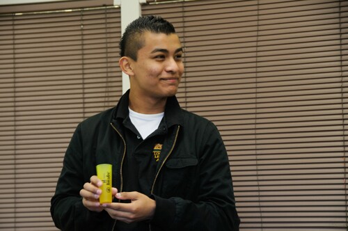How does a shot glass connect this young man to his neighborhood?