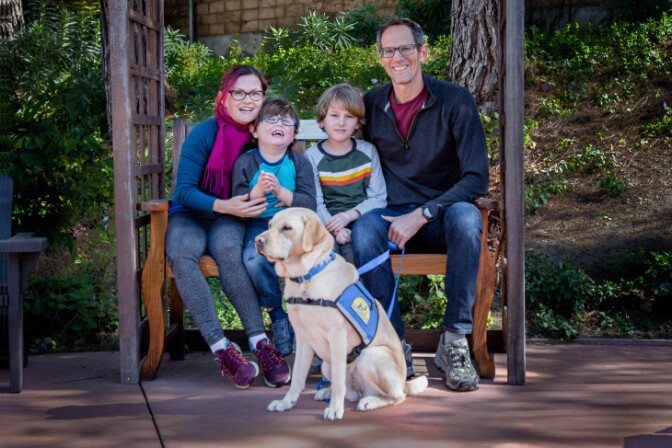 From left to right: Kelley, Aaron, Sean and Eric Coleman. Six-year-old Aaron is a kindergartener at Coldwater Canyon Elementary who receives special education services. In the foreground is Aaron's therapy dog, Heddie. | Courtesy of the Coleman family