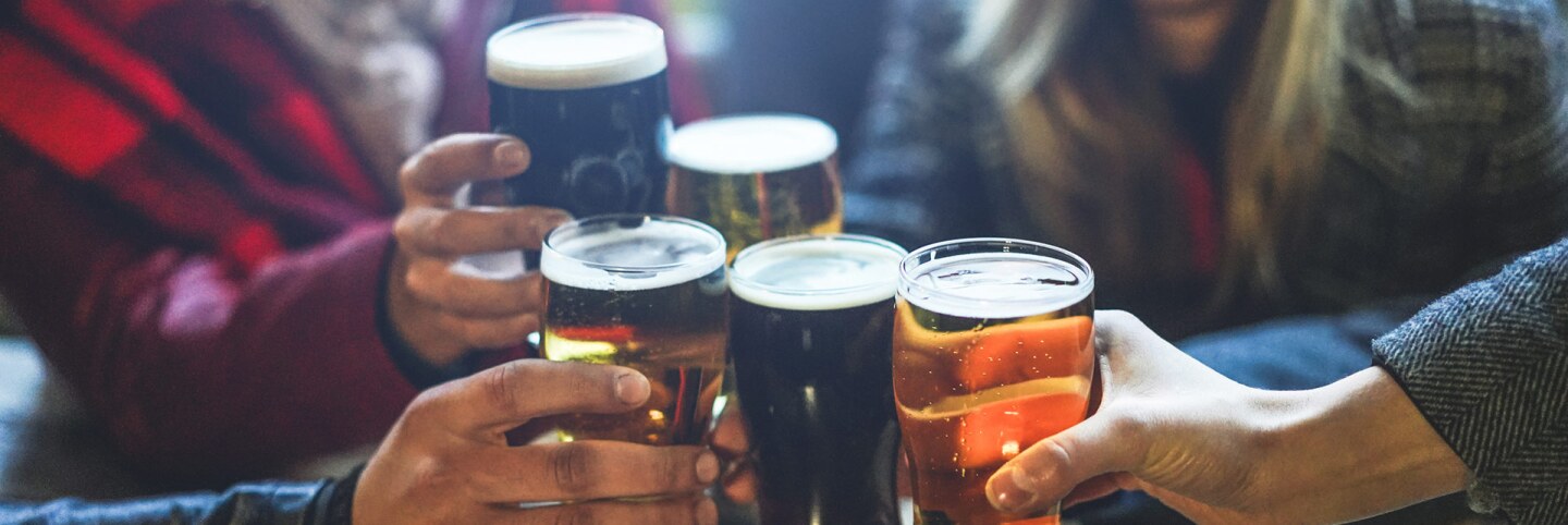 A group of friends drinks beer together. | iStock via Getty Images