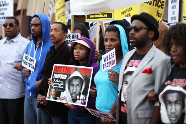 People walk in a silent protest march to demand justice for the shooting of Trayvon Martin, on April 9, 2012 in Los Angeles, California. Photo by David McNew/Getty Images