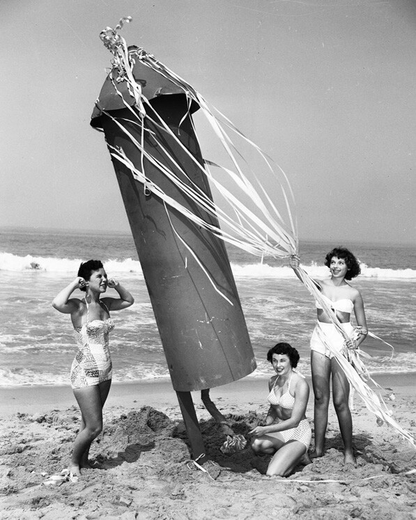 Women play with a giant explosive on Ocean Park Beach to promote the beach's 1952 Independence Day festivities.