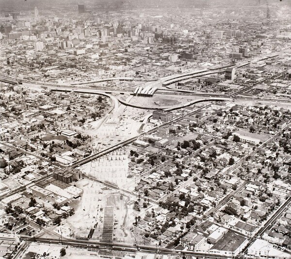 Construction of the Santa Monica Freeway divided neighborhoods and displaced residents. Here, work continues on the freeway southwest of downtown L.A. Courtesy of the Los Angeles Examiner Collection, USC Libraries.