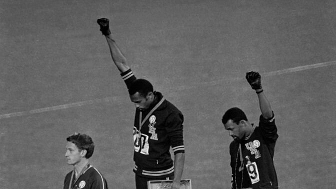 Track and field athletes Tommie Smith and John Carlos raise their fists at the medal podium in a Black Power salute at the 1968 Summer Olympics. | "The Stand"