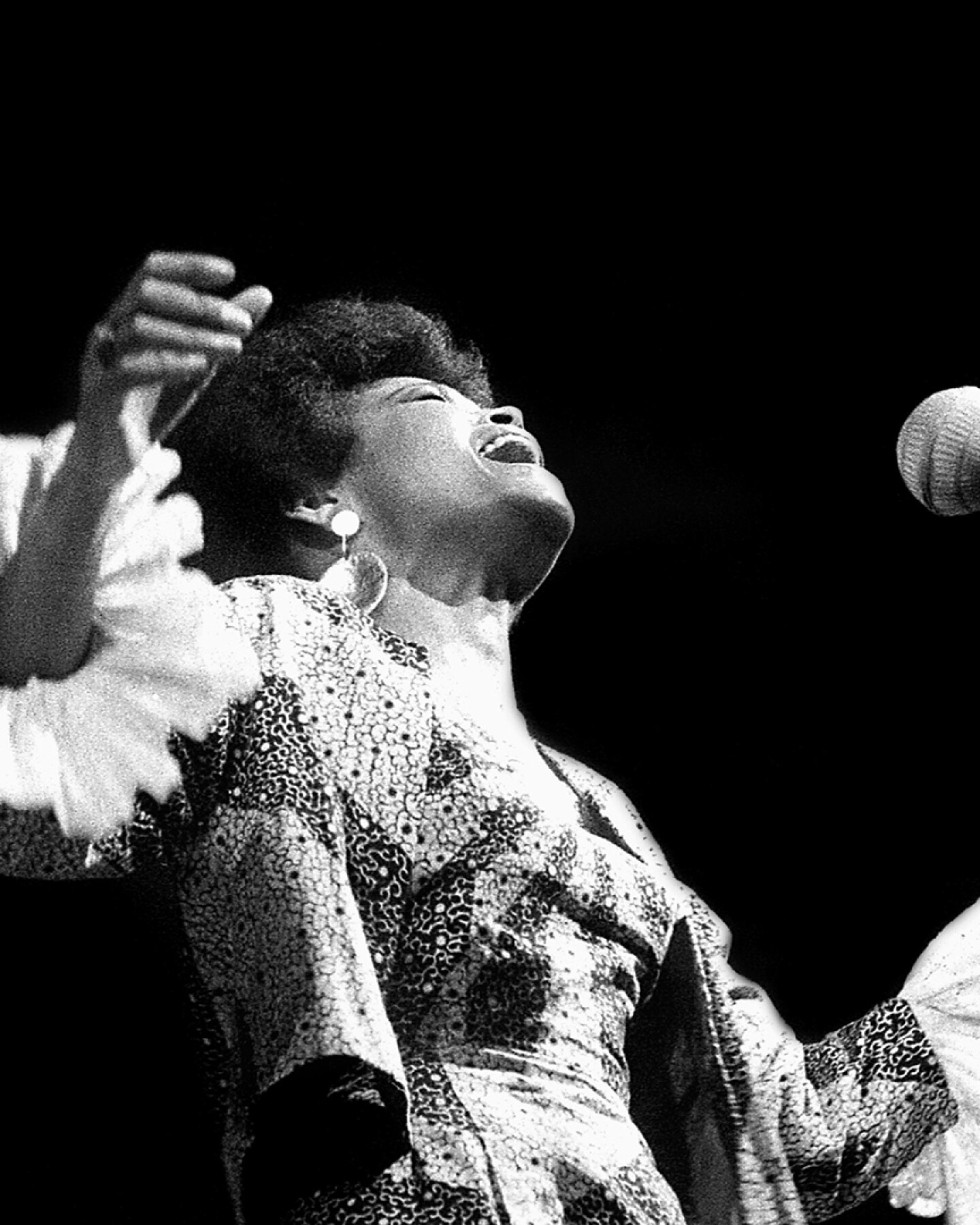 A singer belts out in song during a performance.