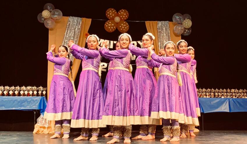 Young Indian American women wearing traditional garb from North India performing kathak