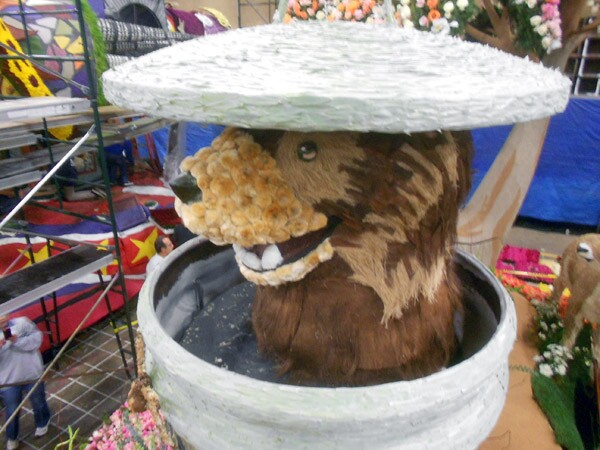 The floral likeness of Glendale's Meatball The Bear adorns that city's Rose Parade float, which implores its human residents, 'Let's Be Neighbors' with its wild animal denizens.