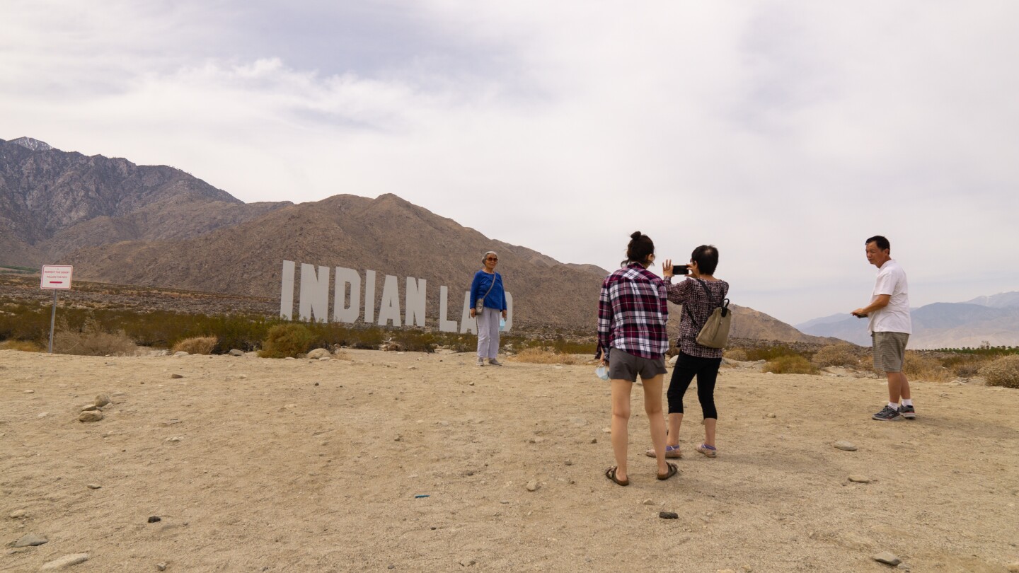 Nicholas Galanin's "Never Forget" installation consists of the words "Indian" and "Land" writ large like the Hollywood sign.