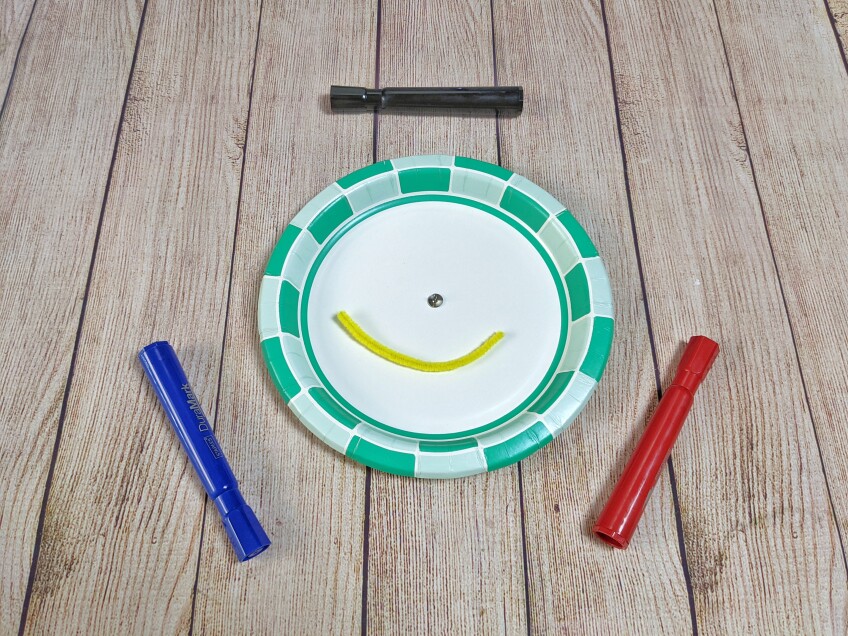 All you need for the spinner is a paper plate, a round head fastener, a pipe cleaner and a marker.