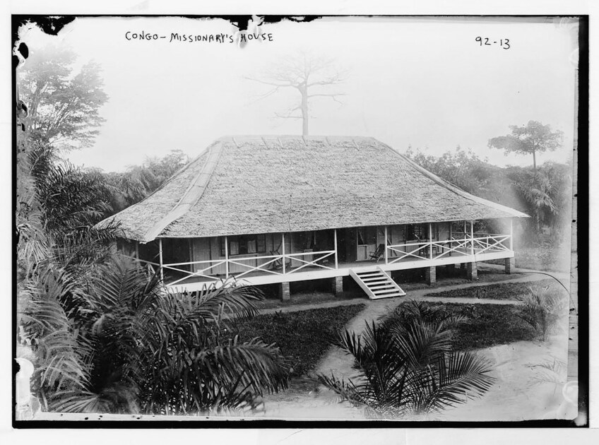 Black and white overhead view of a house made of wood with a wraparound terrace.
