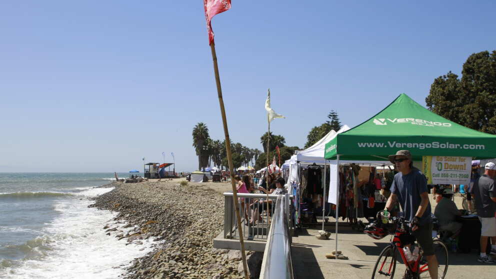 Aloha Beach Festival 2026, photo of market tents on a boardwalk next to the ocean shore 