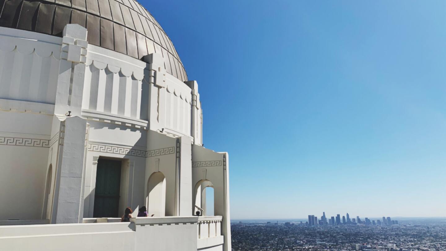 A view of a large domed structure overlooking a cityscape.