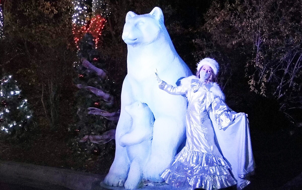 The winter queen poses next to a polar bear sculpture at Holiday in the Park at Six Flags Magic Mountain. | Sandi Hemmerlein