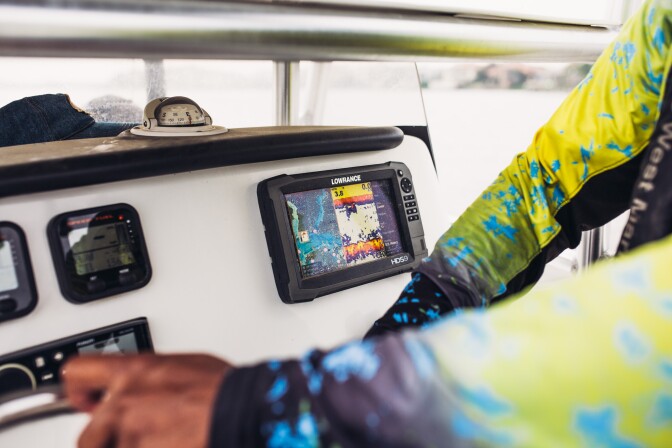 Through real-time sonar, Captain Fred searches for where fish congregate.
