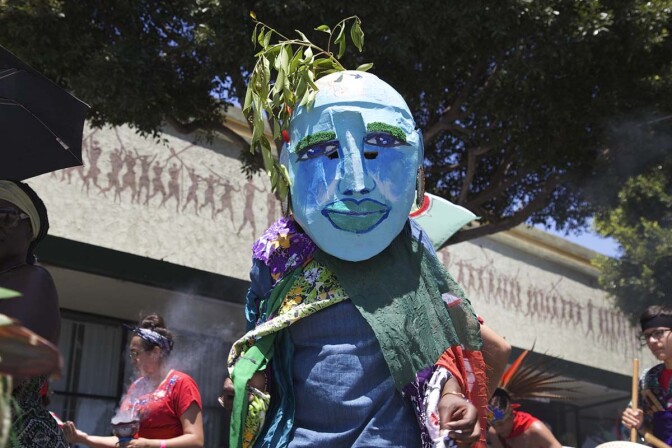 A person walk in a large blue mask at the 2017 edition of the Day of the Ancestors: Festival of Masks. | Photo by Sahra Sulaiman, Courtesy of LA Commons