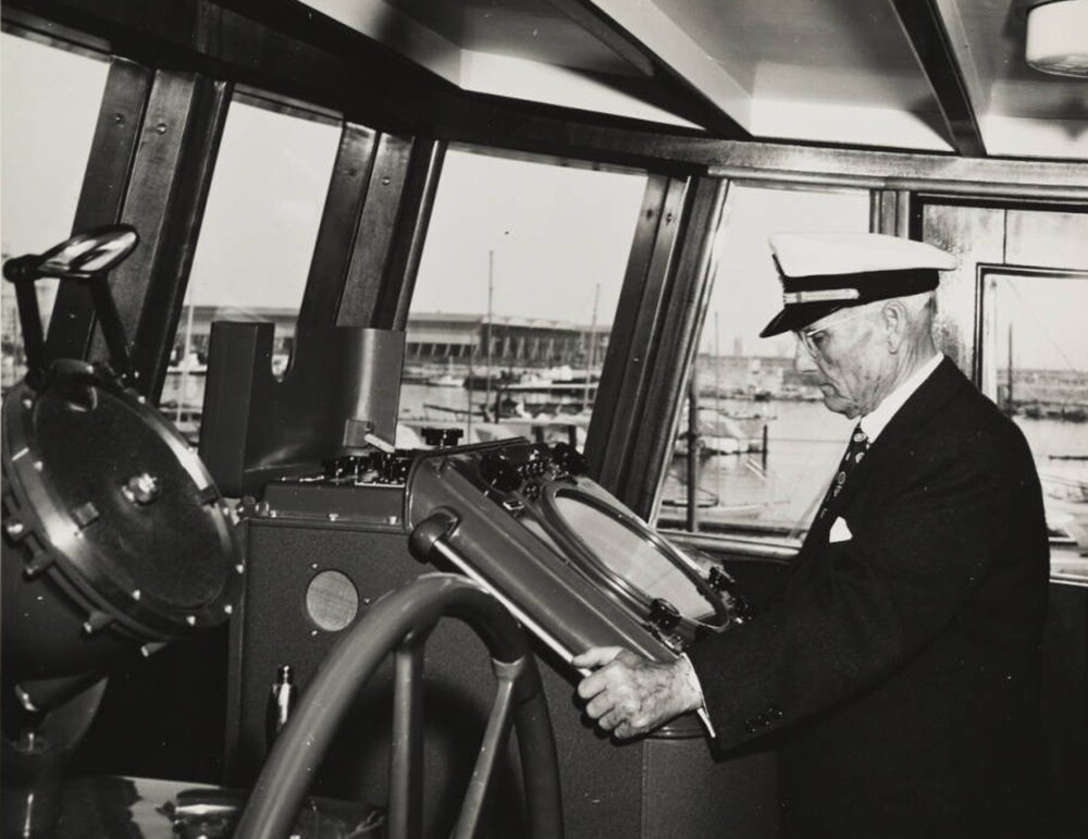 Captain Allan Hancock at gyroscope in pilot house of Velero IV, near Santa Catalina Island, Channel Islands, California, USA, ca. 1949-1950. | Allan Hancock Foundation Collection, USC Libraries