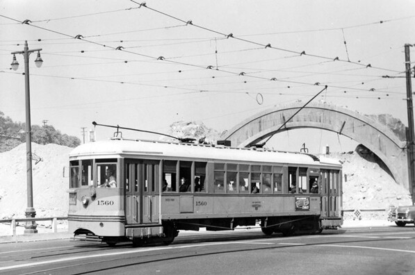A Los Angeles Railway streetcar bypasses the demolished Broadway tunnel, its entrance arch still standing, in 1949. Courtesy of the Los Angeles Public Library Photograph Collection.