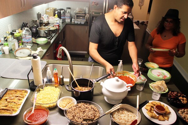 Host Ramy Eletreby sets up the Iftar (breakfast) with traditional Middle Eastern dishes. I Photo: Jonathan Olivares
