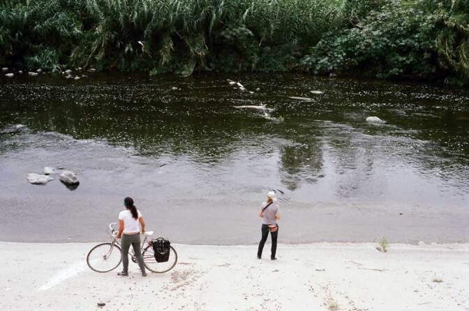 Two women admire the L.A. River from the concrete riverside. | Taylor Fitz-Gibbon
