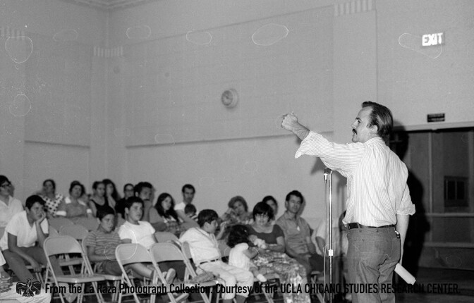 CSRC_LaRaza_B12F26S3_N010 Raul Ruiz speaks at a La Raza Unida meeting | La Raza photograph collection. Courtesy of UCLA Chicano Studies Research Center