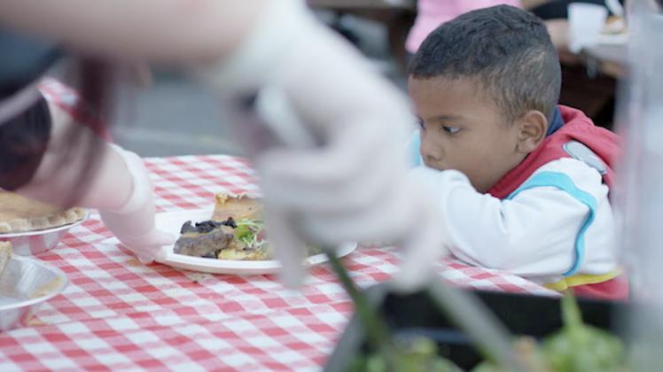 Child enjoys Bracken's Kitchen meal