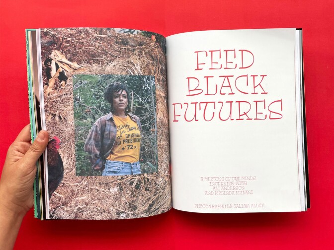 An opened issue of Salima magazine features a portrait of a woman on the left and the words, "Feed Black Futures" written in stylized red text on the right. The magazine is held open by a hand and sits on top of a red background.