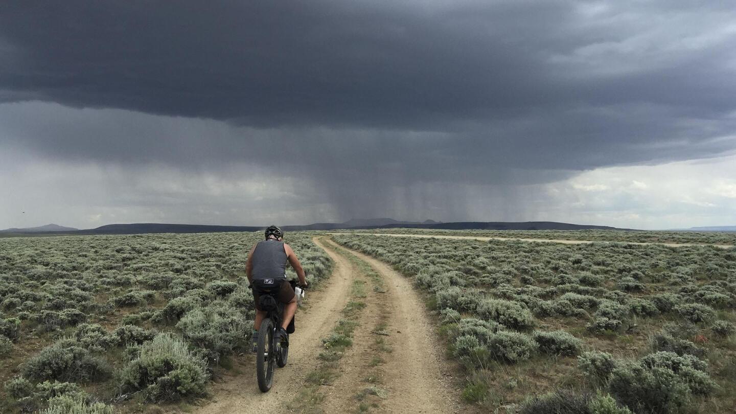 biker-on-dirt-road-cloudy