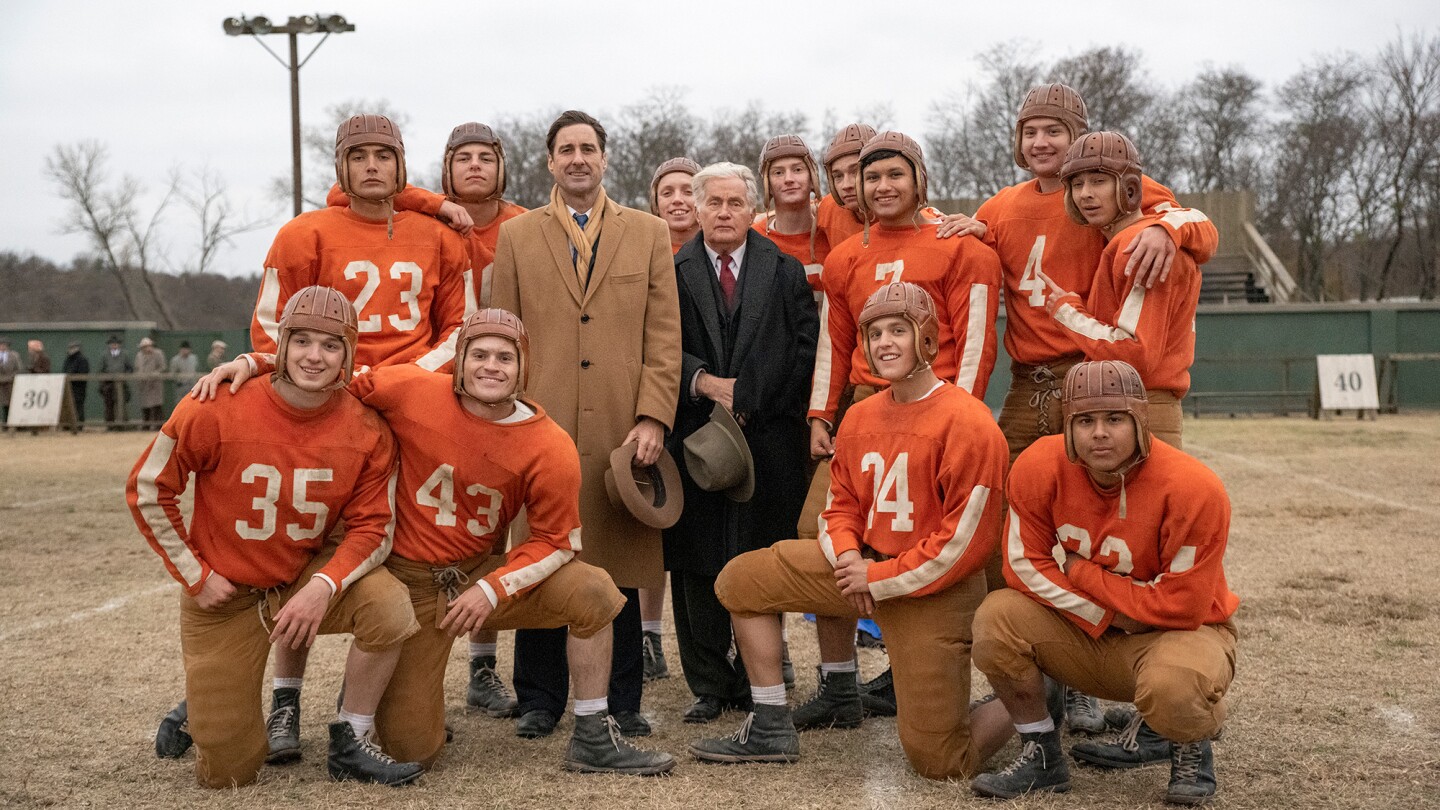 A football team poses for a group photo.