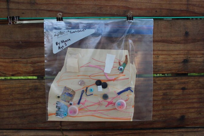 "Fauxlijolij" a piece made of found objects resembling fish by child artist Mona hangs on Dan Fields’ Los Feliz fence gallery.