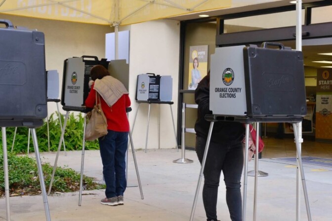 People vote at the O.C. Registrar. | Chava Sanchez/LAist