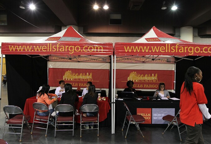Wells Fargo employees holding a free workshop for customers facing mortage payment challenges in Oakland, CA, April 26, 2010. | Justin Sullivan/Getty Images