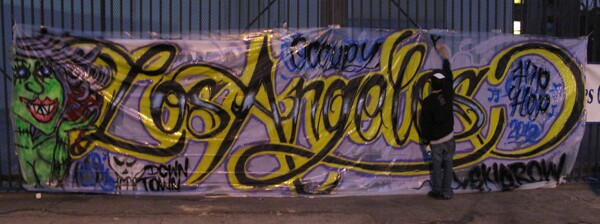 A muralist at work during the Operation Skid Row Festival