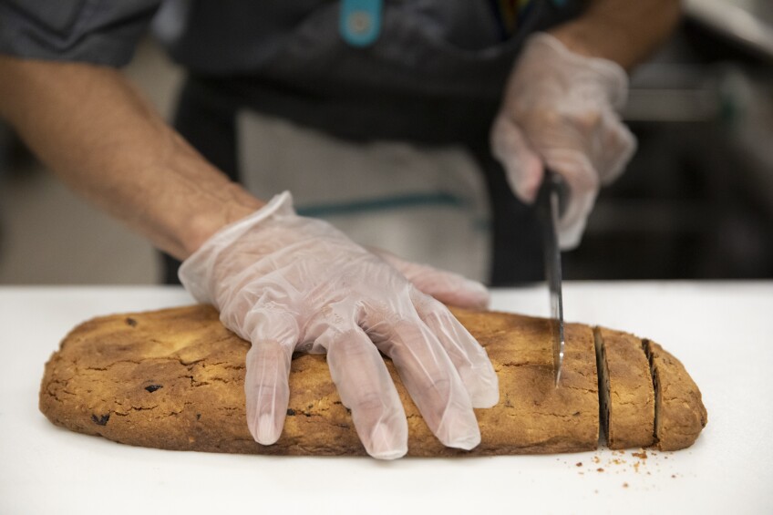 The final biscotti is sliced into its iconic shape.