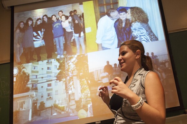 Lilian M explained why her home is not the Brazil apartment building behind her, but the friends who don't live there now but gather in other places. | Photo by Douglas McCulloh