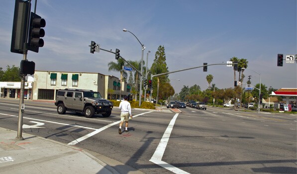 Pedestrian crosses Magnolia Ave in Riverside. Photo: Ed Fuentes